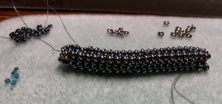July 21 - My latest project. Jo says it looks like a beaded caterpillar. Size 11 and 15 demi beads. Tiny!